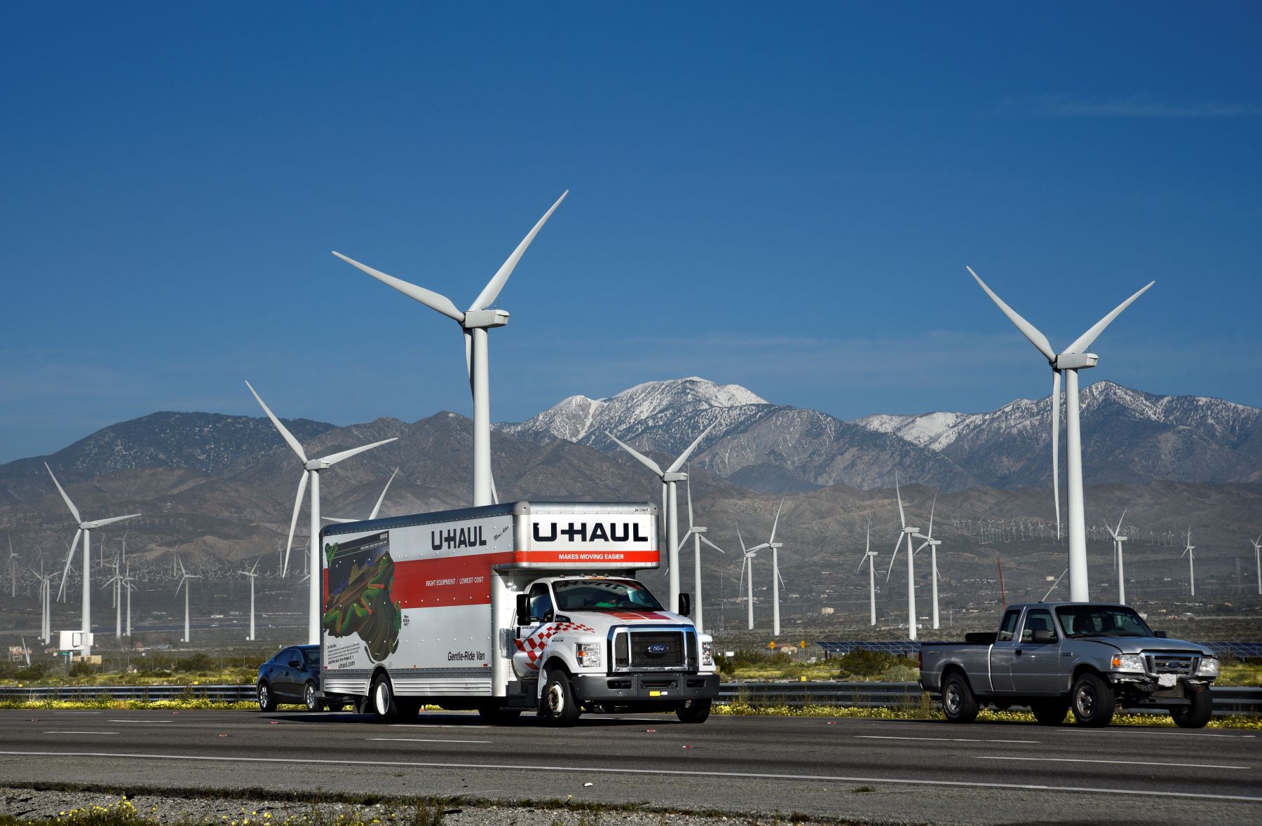 A U-Haul truck driving past a wind farm in Palm Springs, California