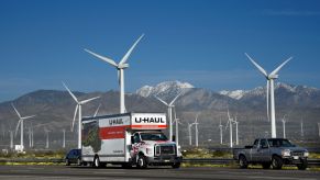 A U-Haul truck driving past a wind farm in Palm Springs, California