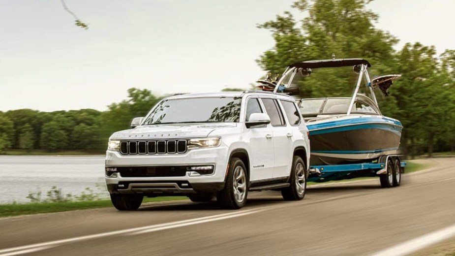 White 2022 Jeep Wagoneer, the only SUV that can tow 10,000 pounds, towing a boat