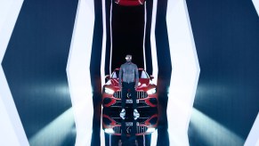 Will.I.Am standing in front of a red Mercedes AMG GT 63 S E Performance during press release photoshoot