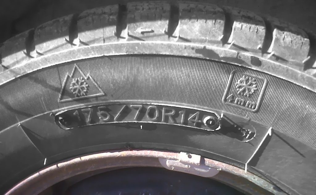 The three-peak symbol displayed on the sidewall of a tire.