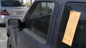 An orange tag on an abandoned car in Florida.
