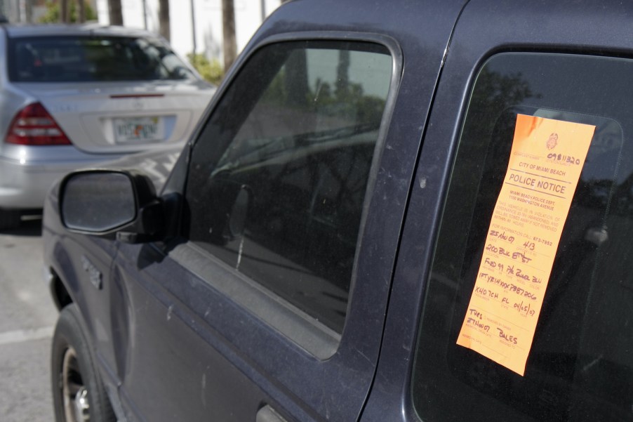An orange tag on an abandoned car in Florida.