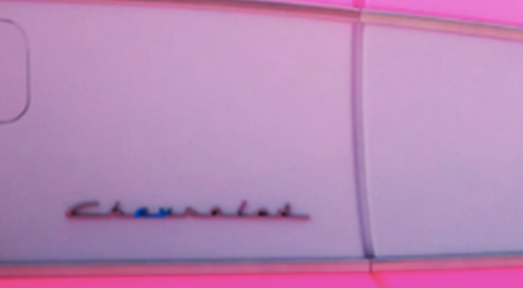A close-up shot of the Chevrolet logo on Barbie's Corvette in the upcoming "Barbie" movie.
