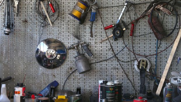Car accessories and tools in an auto garage, including a Volkswagen (VW) hubcap from a Beetle in Kaufbeuren, Germany