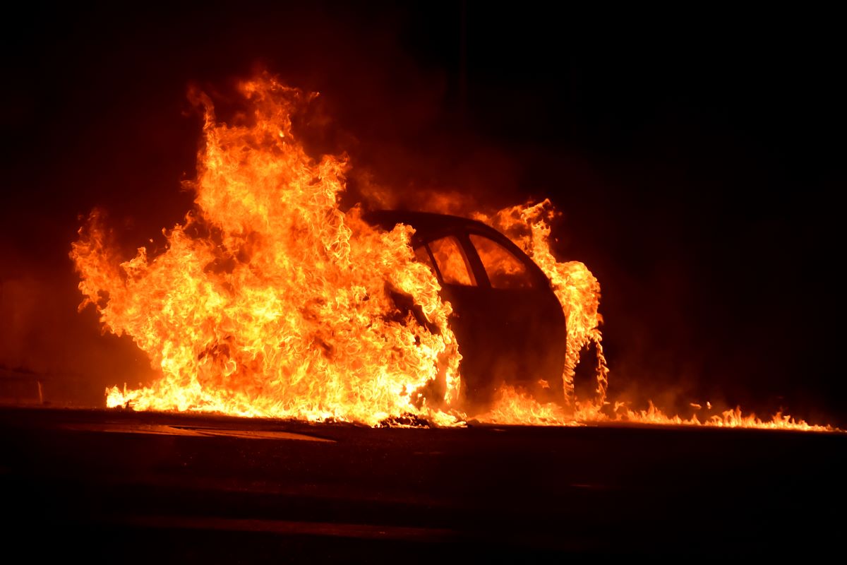 A car completely engulfed in flames. Automotive fire extinguishers can only handle small fires.