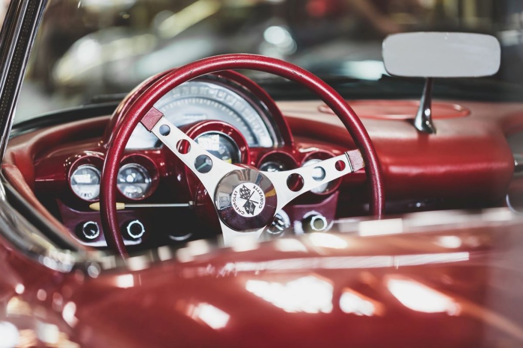 Close up of a steering wheel on an old classic car. Many classic cars are consigned