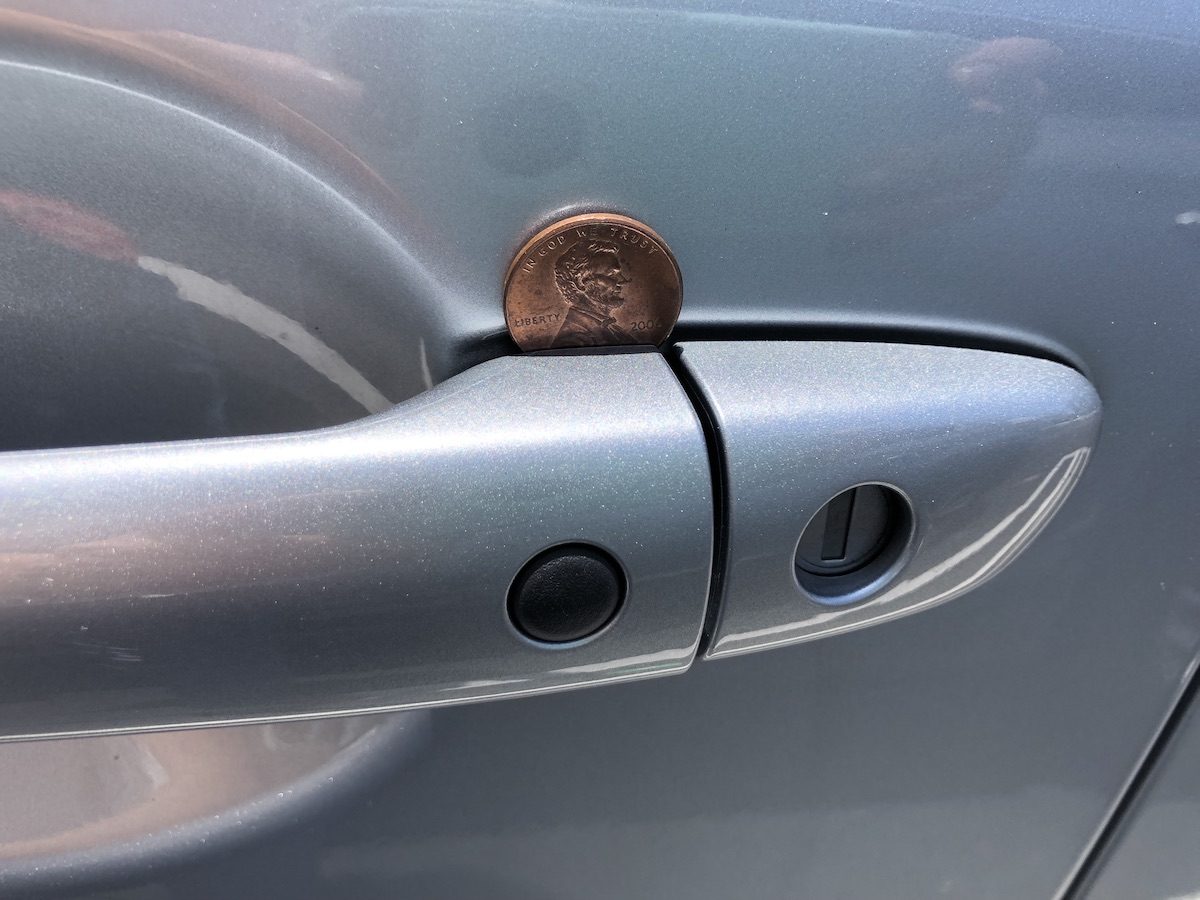 Coin in a car door handle myth