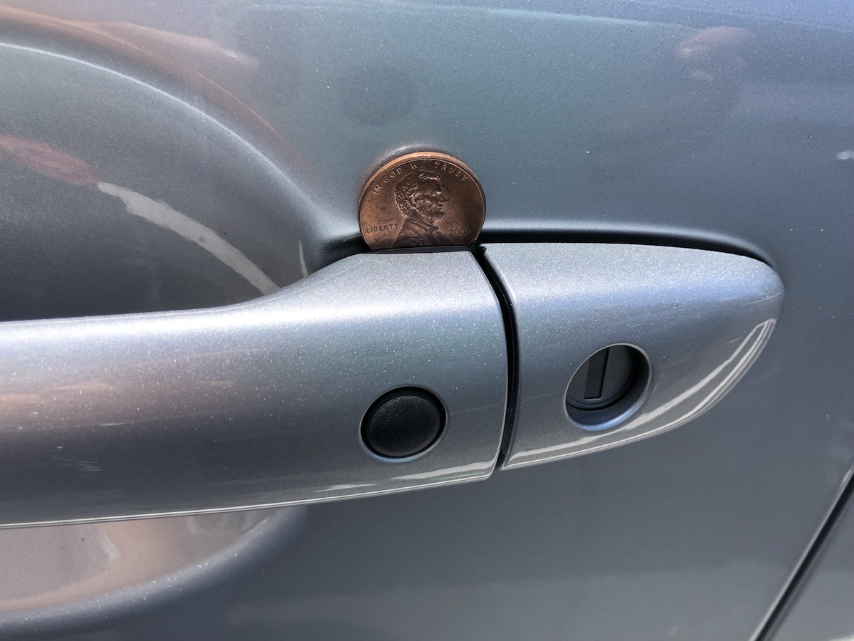 https://www.motorbiscuit.com/wp-content/uploads/2022/05/coin-in-car-door-handle-1.jpg