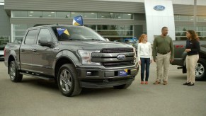 Two people buying a truck at a Ford dealership