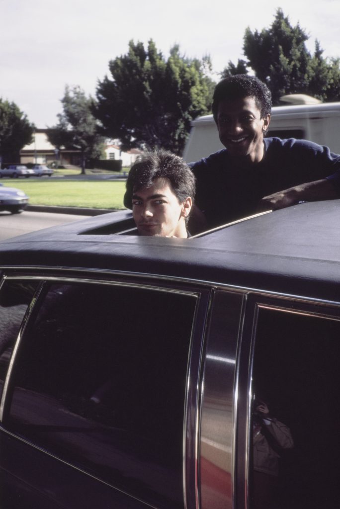 Jon Moss & Mikey Craig hanging from a sunroof