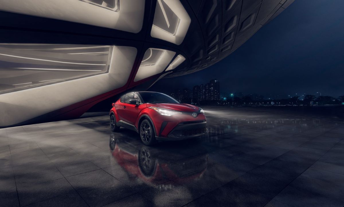 Dark red Toyota C-HR Nightshade Edition in a dark and moody photoshoot location