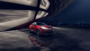 Dark red Toyota C-HR Nightshade Edition in a dark and moody photoshoot location