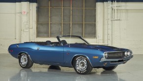 A blue 1970 Dodge Challenger R/T Convertible in a garage