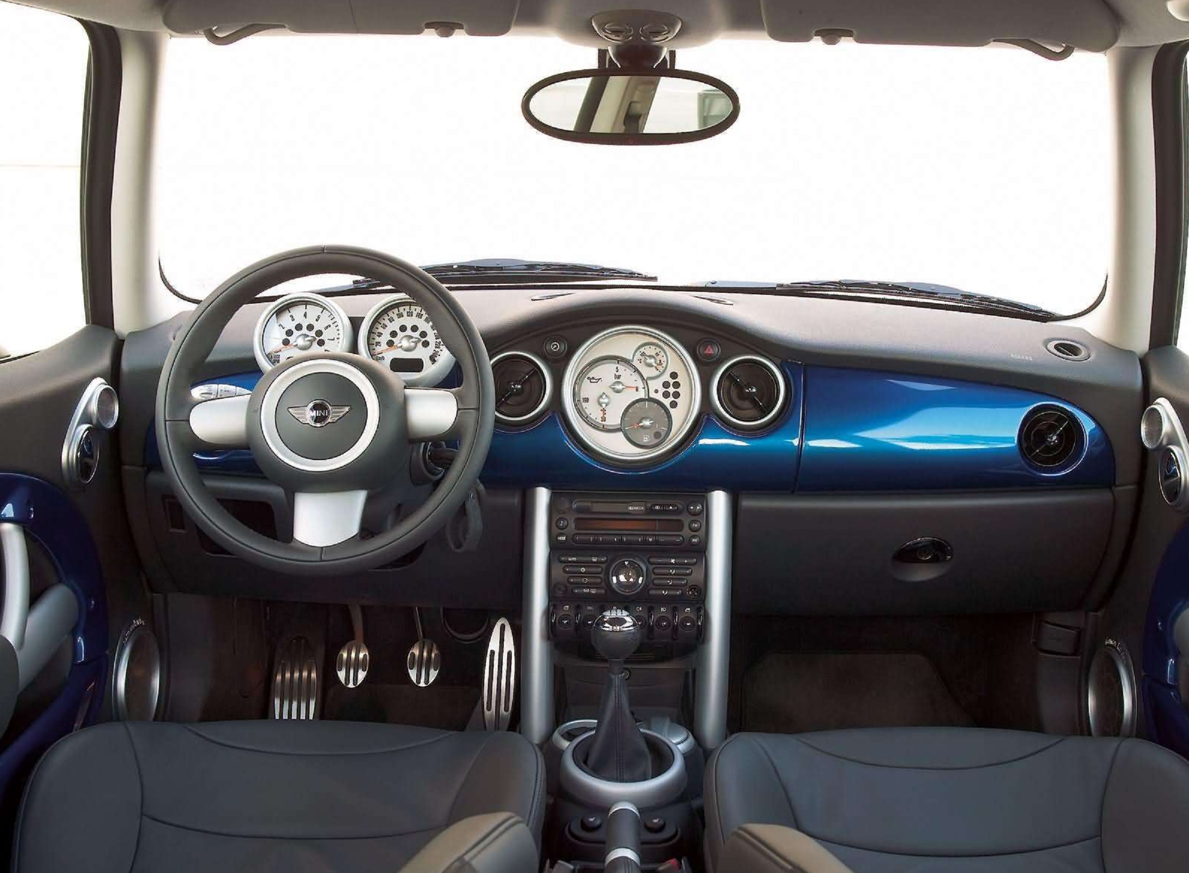 The front seats and blue dashboard of a 2005 R53 Mini Cooper S
