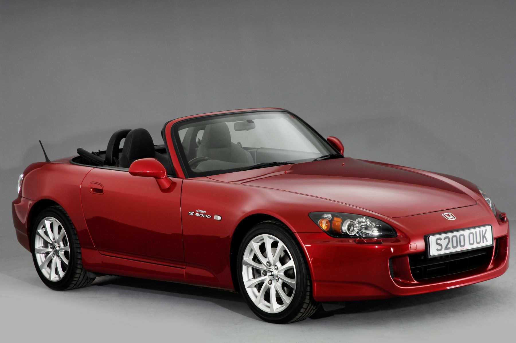 A red 2007 Honda S2000 coupe convertible model featured from the National Motor Museum