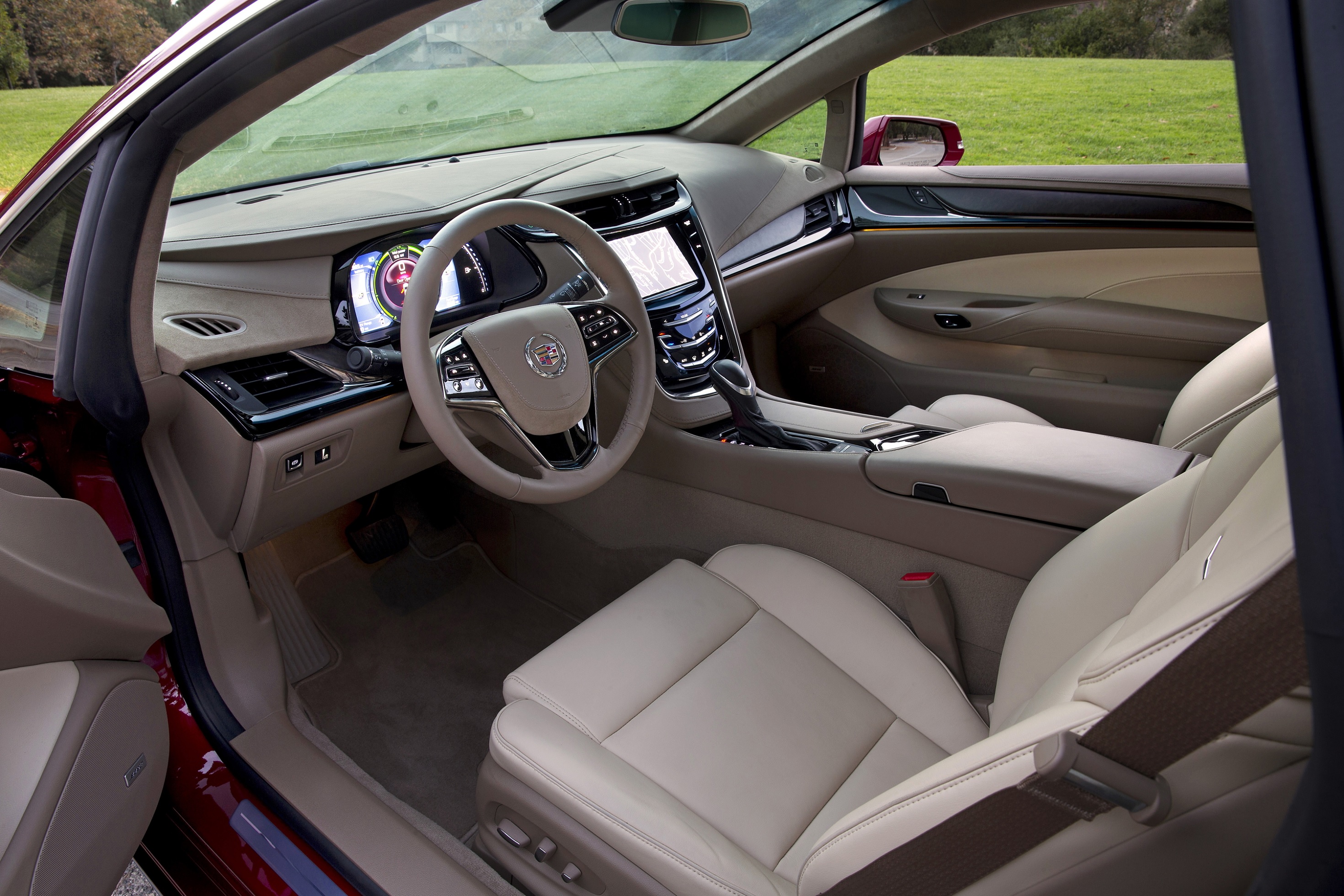 The tan-leather front seats and metal-and-wood dashboard of a 2014 Cadillac ELR