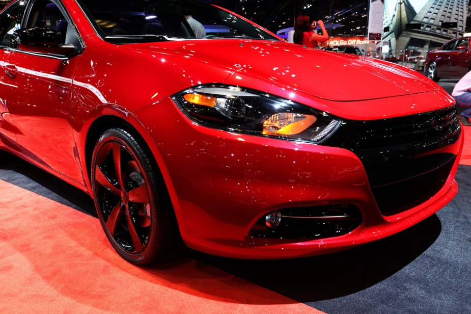A red 2014 Dodge Dart, known for being one of the cheap cars, parked inside.
