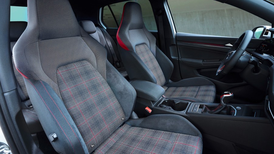Bolstered cloth seats with plaid inserts inside the best used compact car to buy, a 2020 Volkswagen GTI