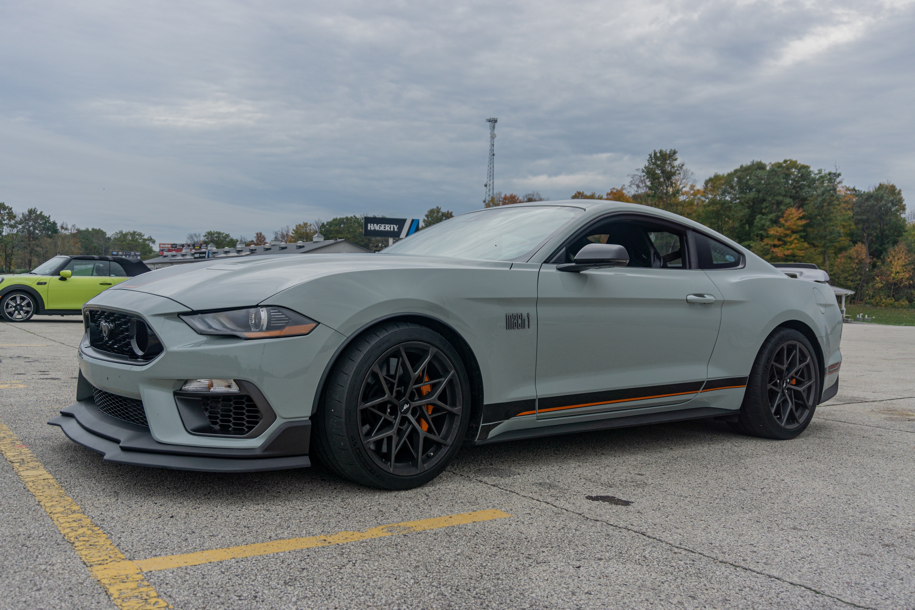 A gray 2021 Ford Mustang Mach 1 with Handling Package in a racetrack parking lot