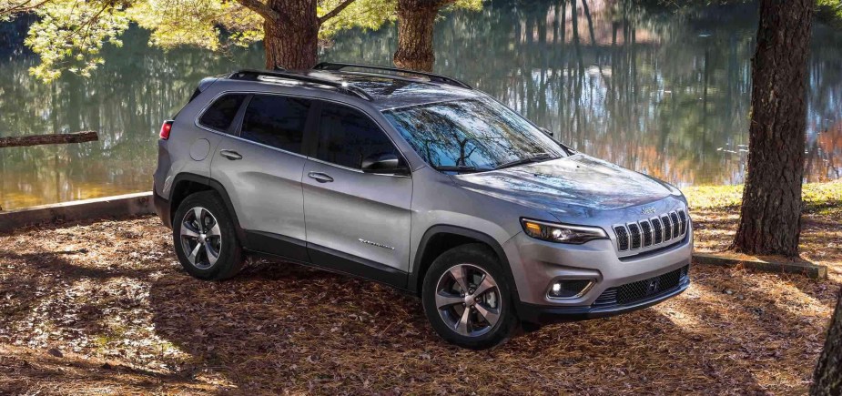 A silver 2022 Jeep Cherokee in the woods.
