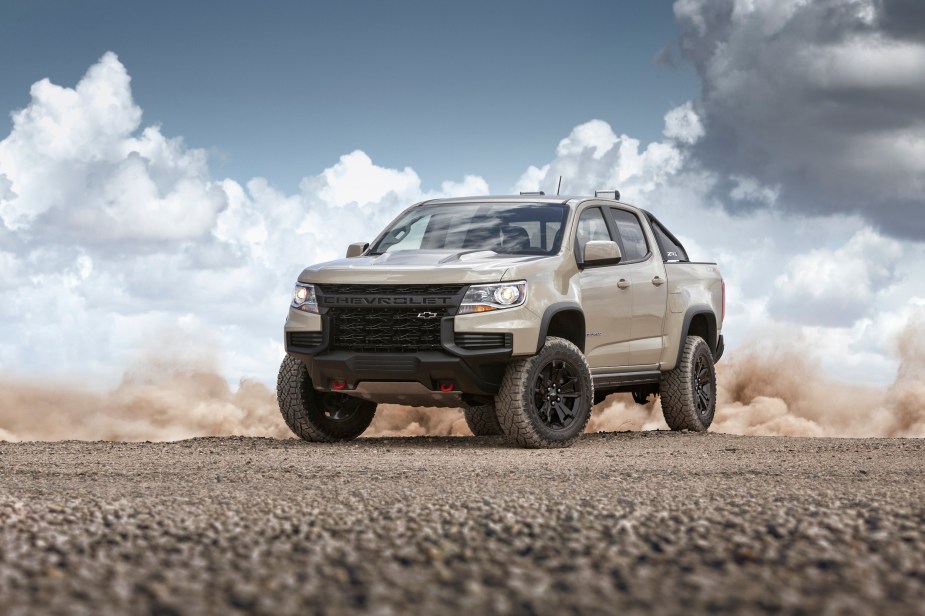 A 2022 Chevrolet Colorado ZR2 driving in the dirt. Does it get better fuel economy than the Silverado?