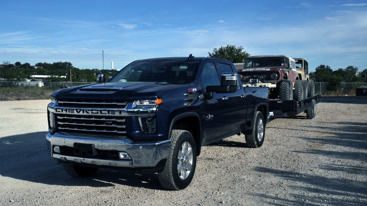 This 2022 Chevrolet Silverado 2500 HD Diesel is pulling a couple of off-road vehicles to the trailhead.