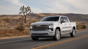 A silver 2022 Chevy Silverado driving down the road.