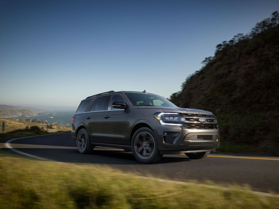 A grey 2022 Ford Expedition driving up a mountain outside. 