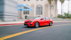 The 2022 Honda Civic, pictured here in a corner, goes toe-to-toe with the 2022 Kia Forte.