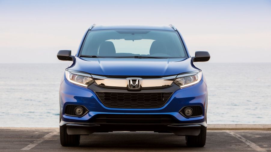 A blue 2022 Honda HR-V subcompact SUV parked near a body of water