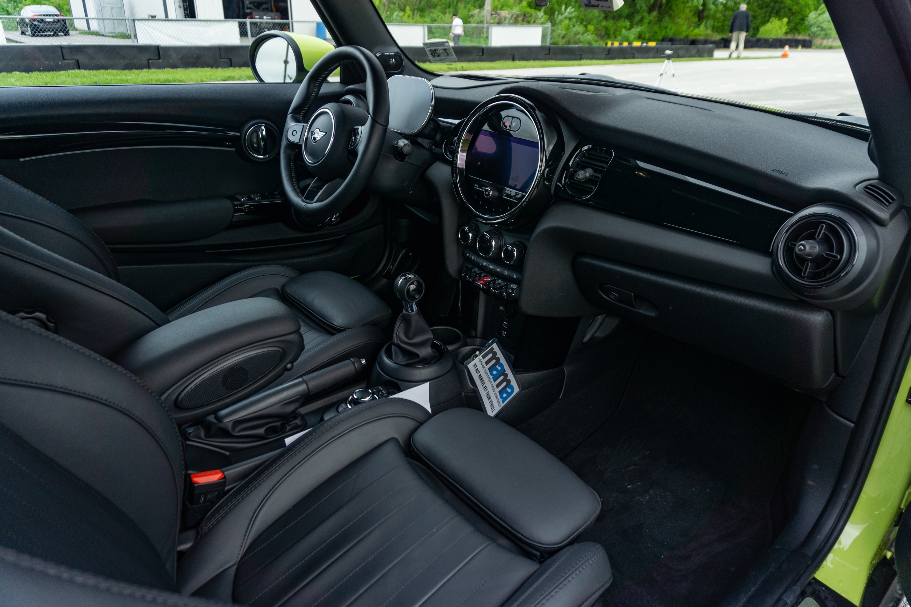 The black front seats and dashboard of a 2022 Mini Cooper S Convertible