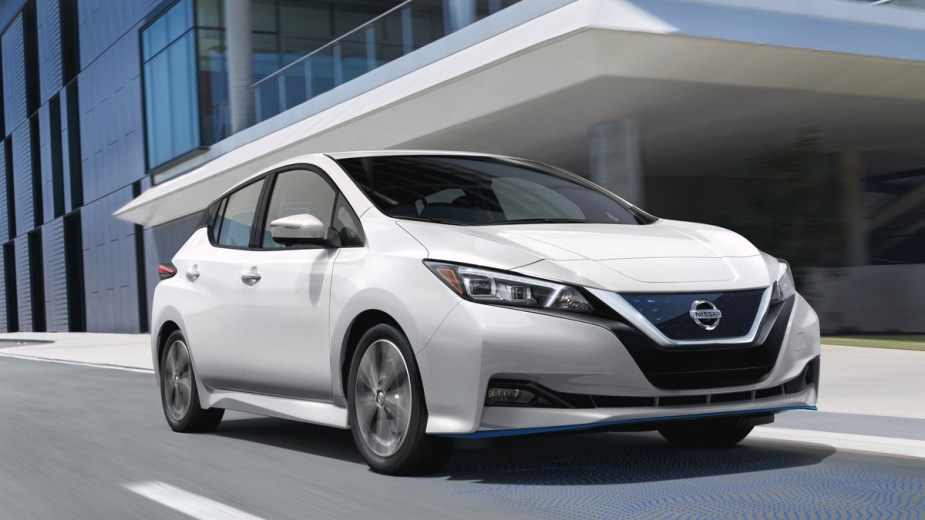 a new nissan leaf on the road, a great choice for shoppers looking for a new car to save money on high gas prices for road trips