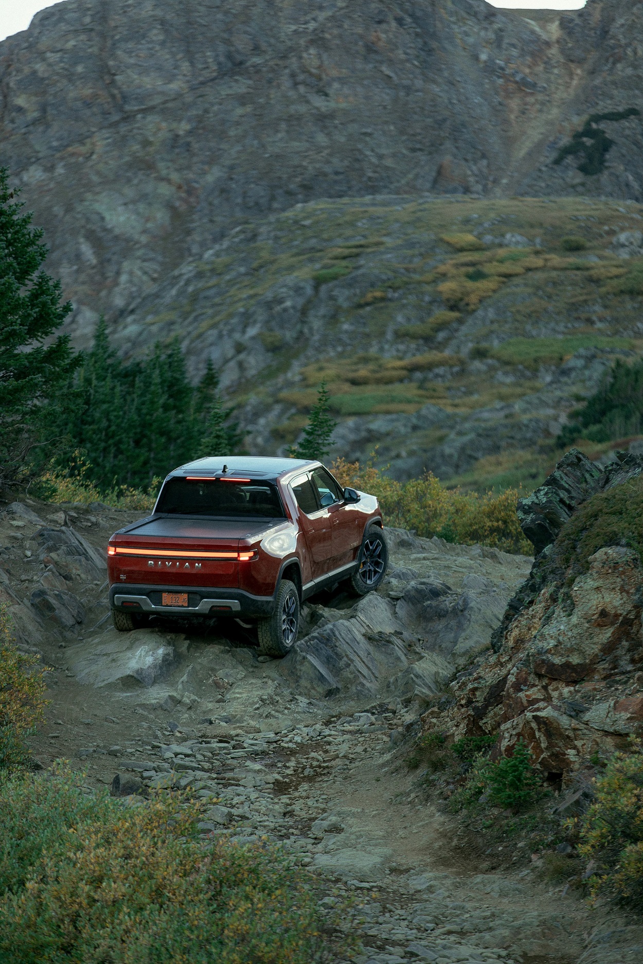 a 2022 Rivian R1T in red in the dirt
