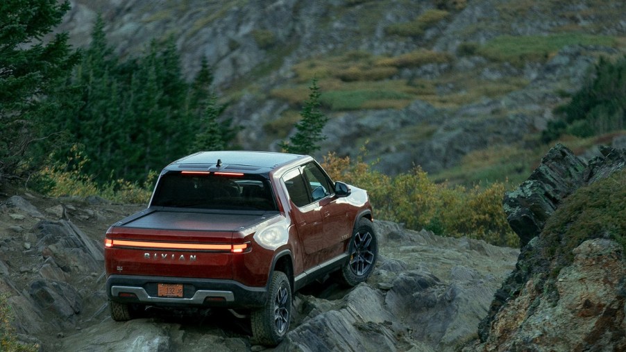 a 2022 Rivian R1T in red in the dirt