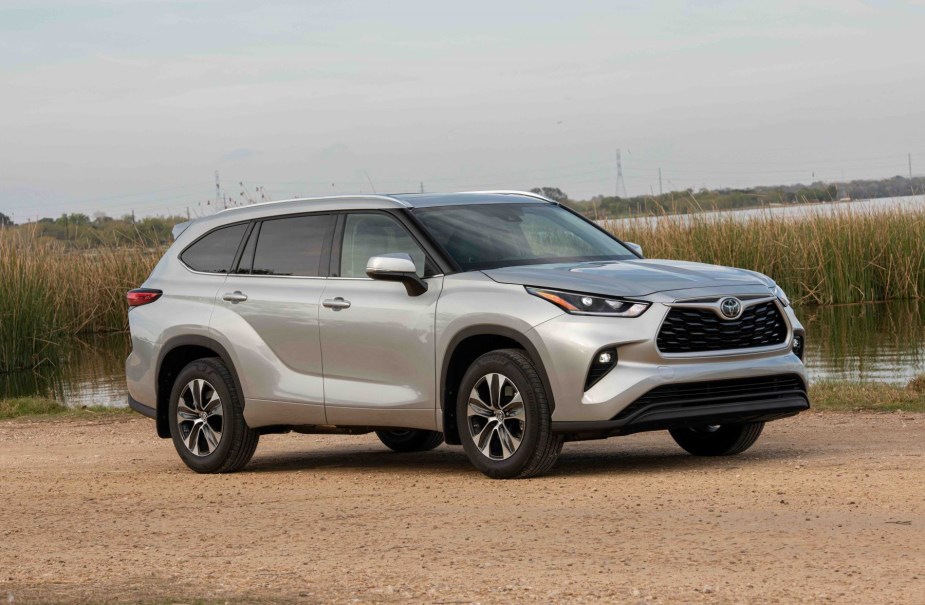 A silver gray 2022 Toyota Highlander XLE midsize SUV. How do the price, engine, features, and size compare to the RAV4?