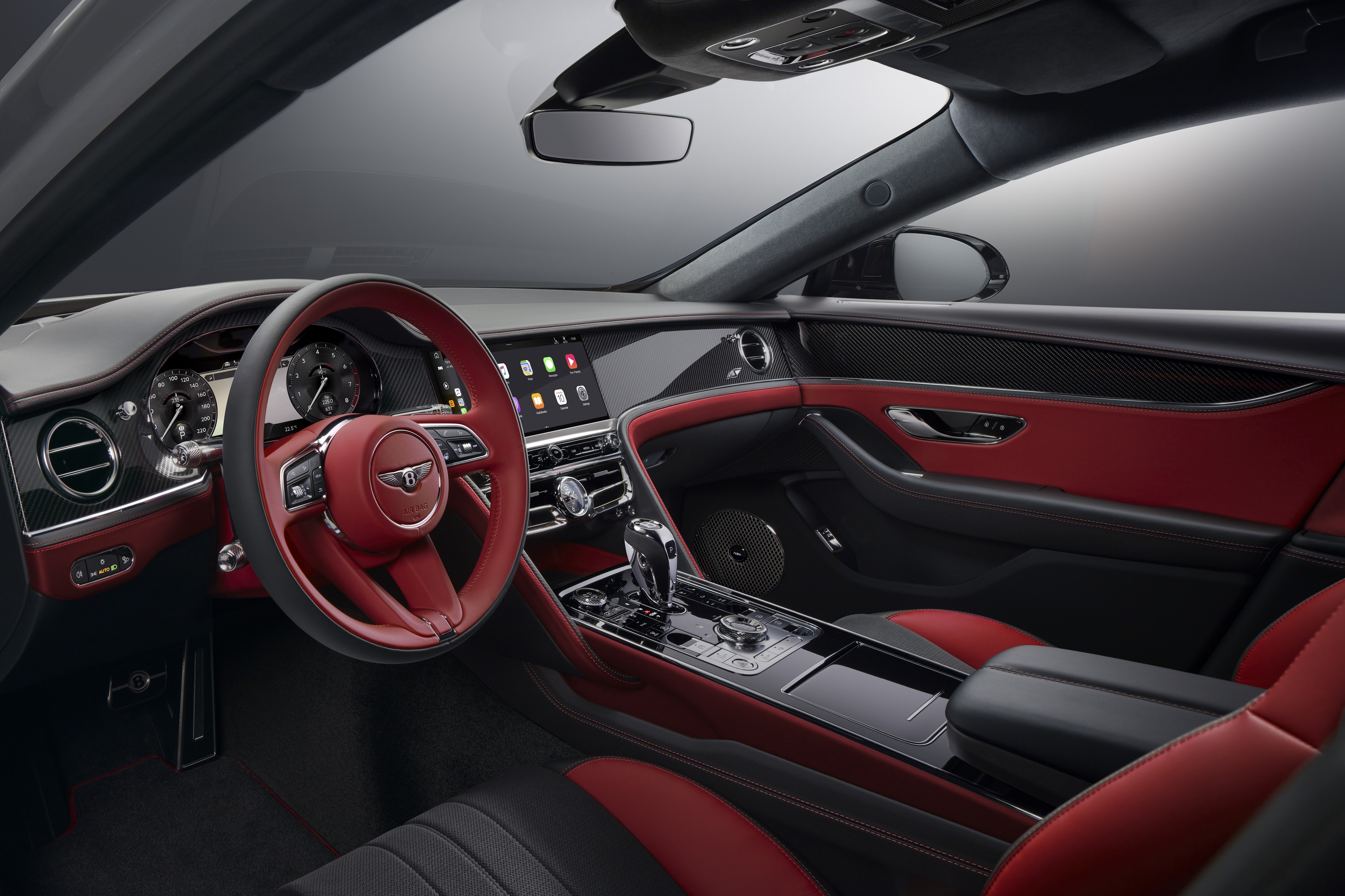 The black-and-red leather-microfiber front seats and dashboard of a 2023 Bentley Flying Spur S