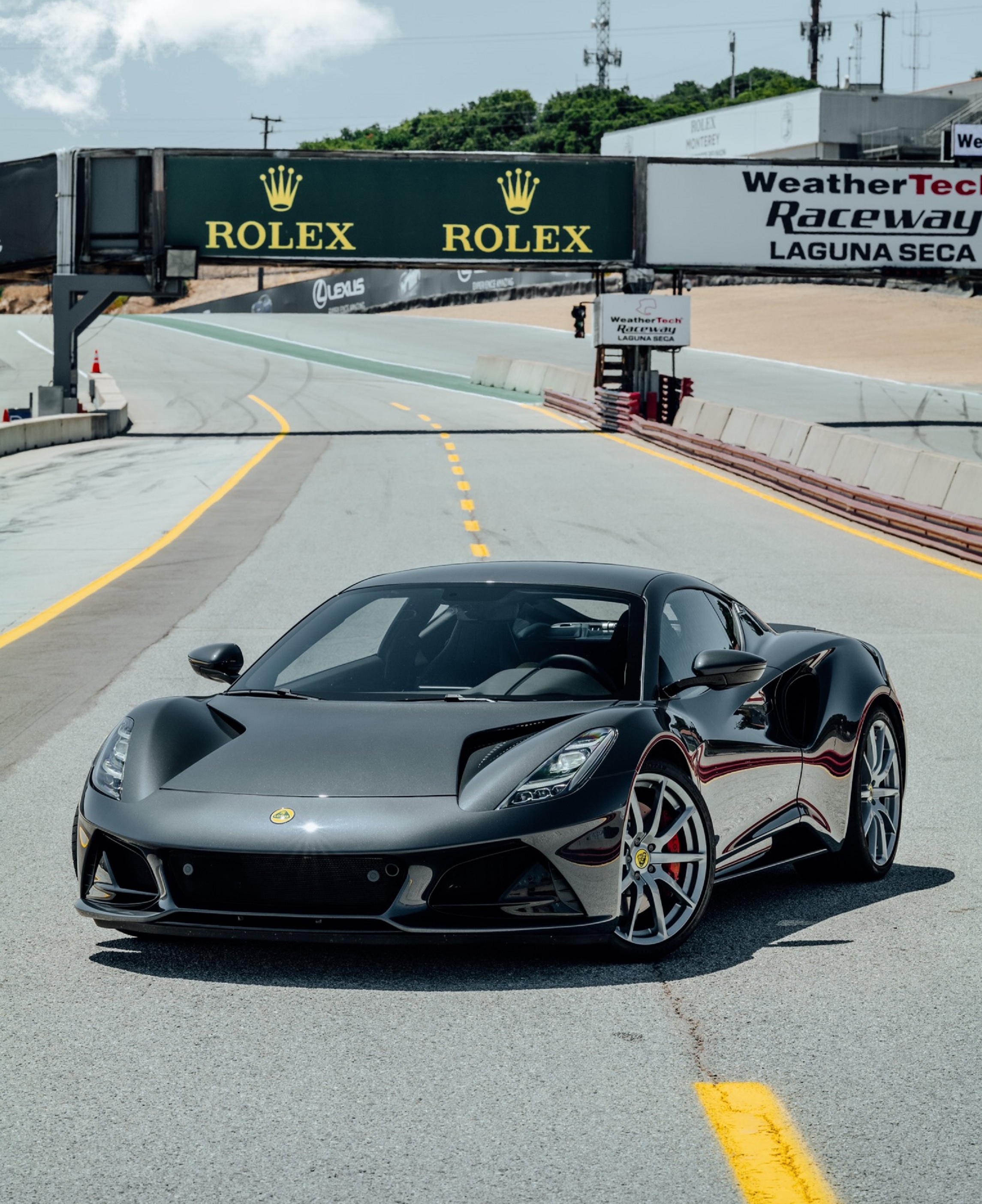 A gray 2023 Lotus Emira on the track at Monterey Car Week 2021