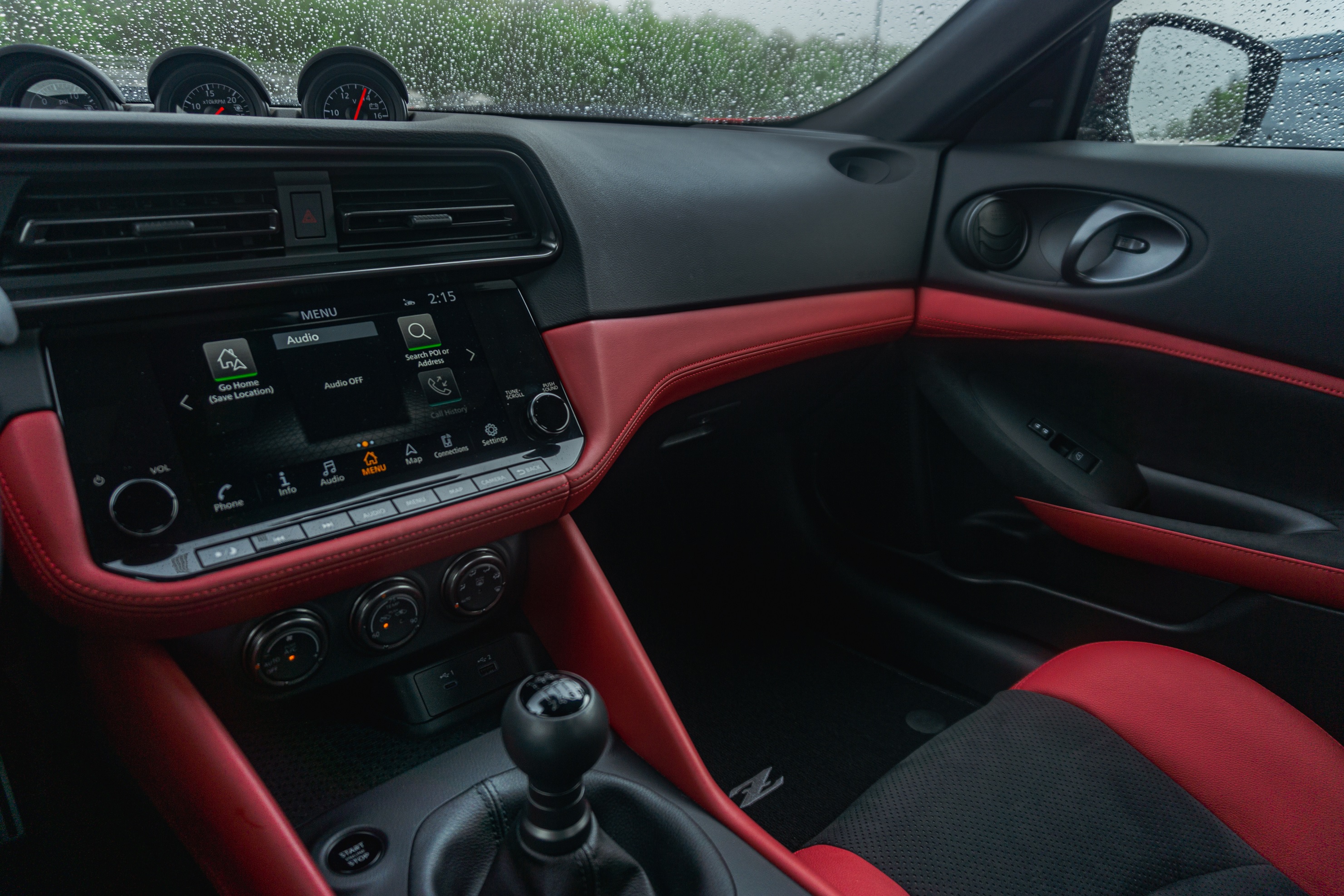 the 9" Touchscreen and black and red leather dashboard of a 2023 Nissan Z Performance