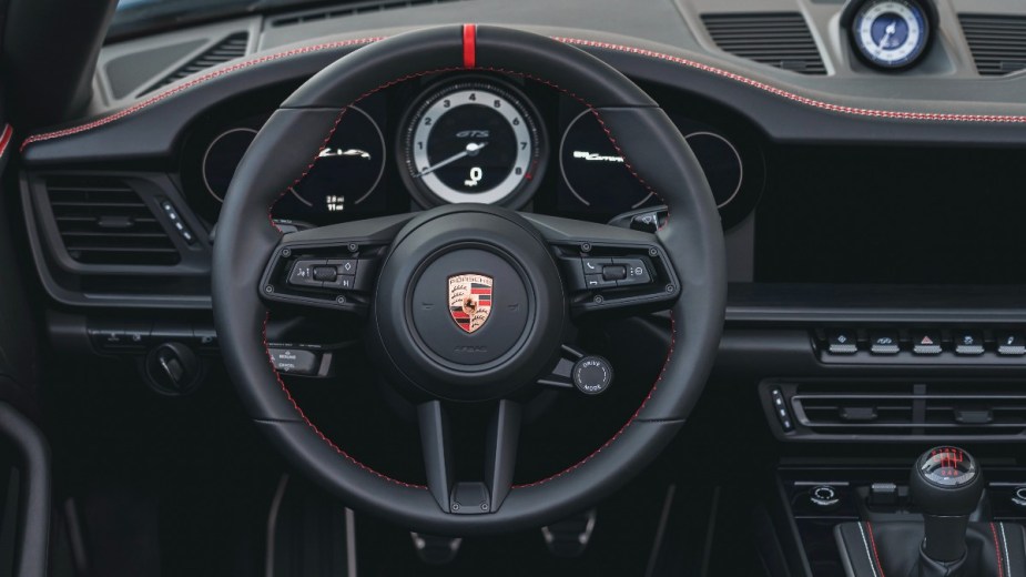 a luxurious and unique interior found inside of a new 2023 porsche 911 carrera gts cabriolet america
