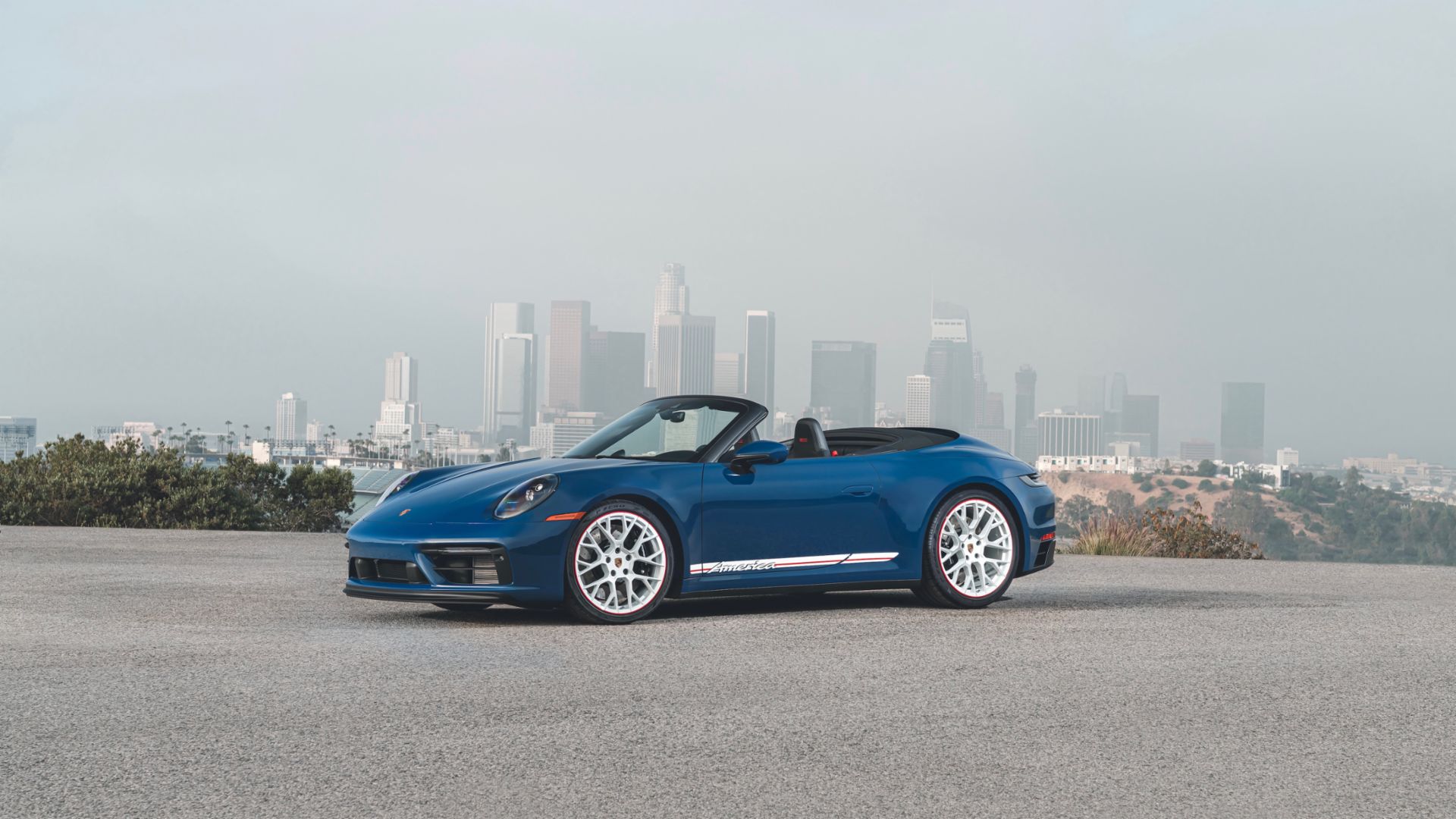2023 Porsche 911 Cabriolet America Edition Parked in front of city skyline