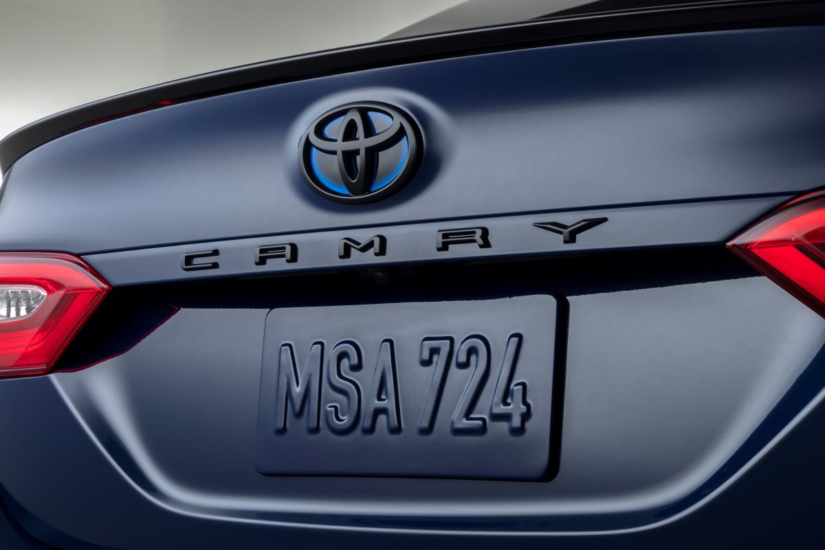 Close up view of the trunk of the 2023 Toyota Camry Hybrid SE Nightshade Edition, with blacked-out rear badges in a dark blue