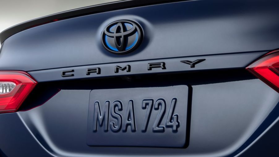 Close up view of the trunk of the 2023 Toyota Camry Hybrid SE Nightshade Edition, with blacked-out rear badges in a dark blue