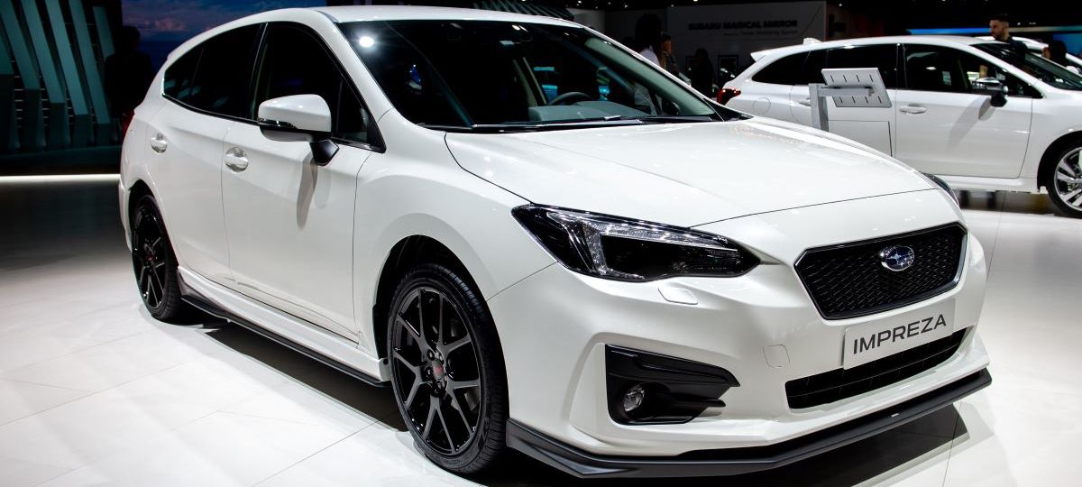 White Subaru Impreza hatchback at an auto showThe S