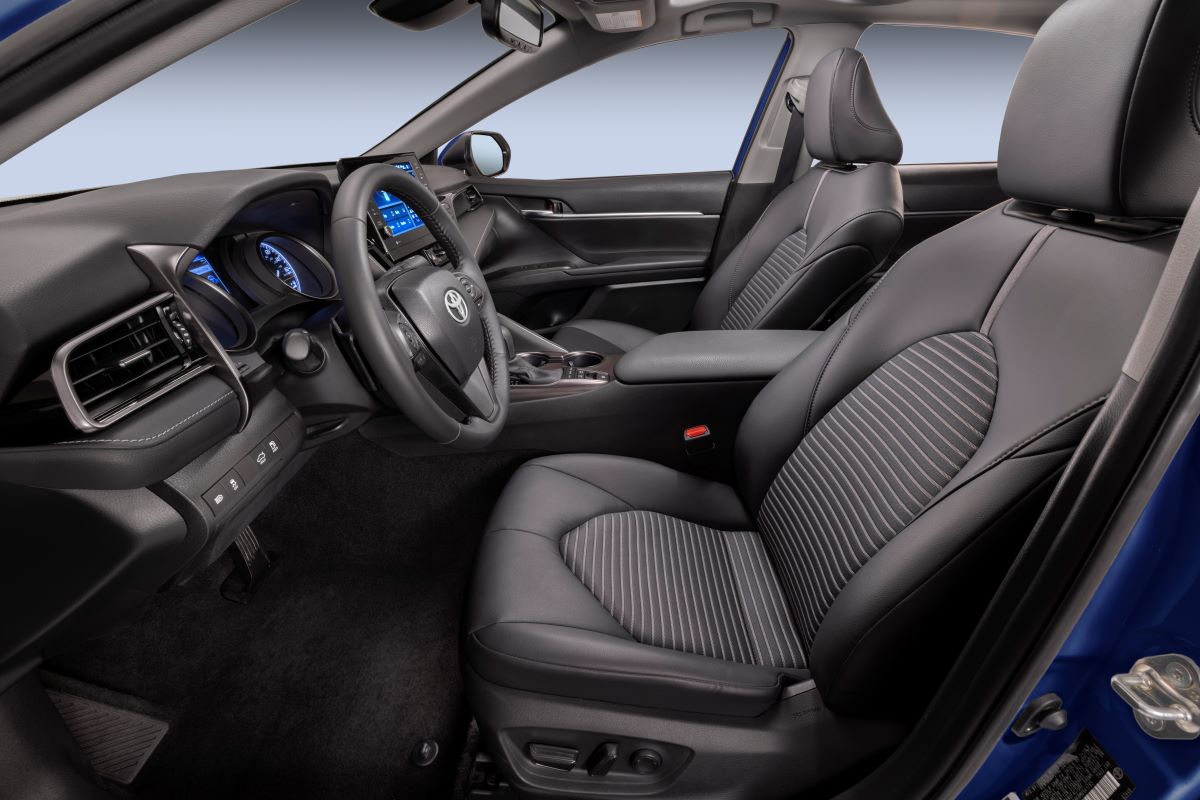 Black cloth interior of the 2023 Toyota Camry Hybrid midsize sedan