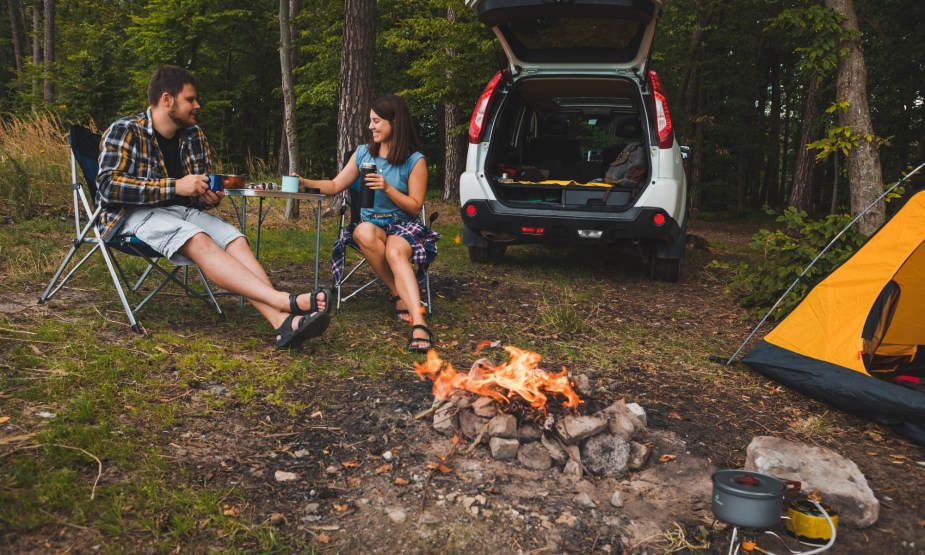 A Couple Enjoying a Campout by Their SUV