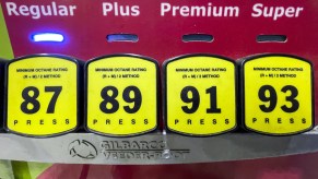 A gas station pump with four different fuel grades: regular, mid-grade, premium, and super