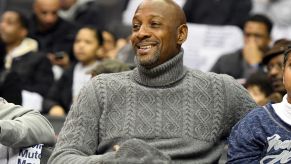 Alonzo Mourning, who did a stint at a Pontiac dealership, wearing a grey sweater sitting in a crowd.