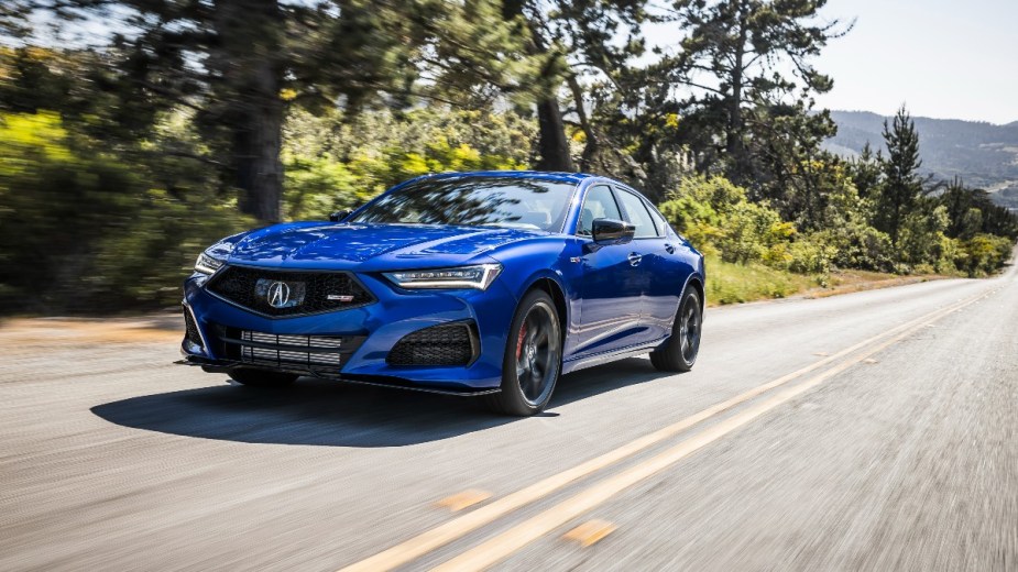 a new blue acura tlx driving along the road showing why its the luxury midsize sedan for you