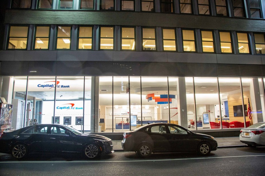 Cars parked on the street in front of a Manhattan Capital One bank that offers car loans